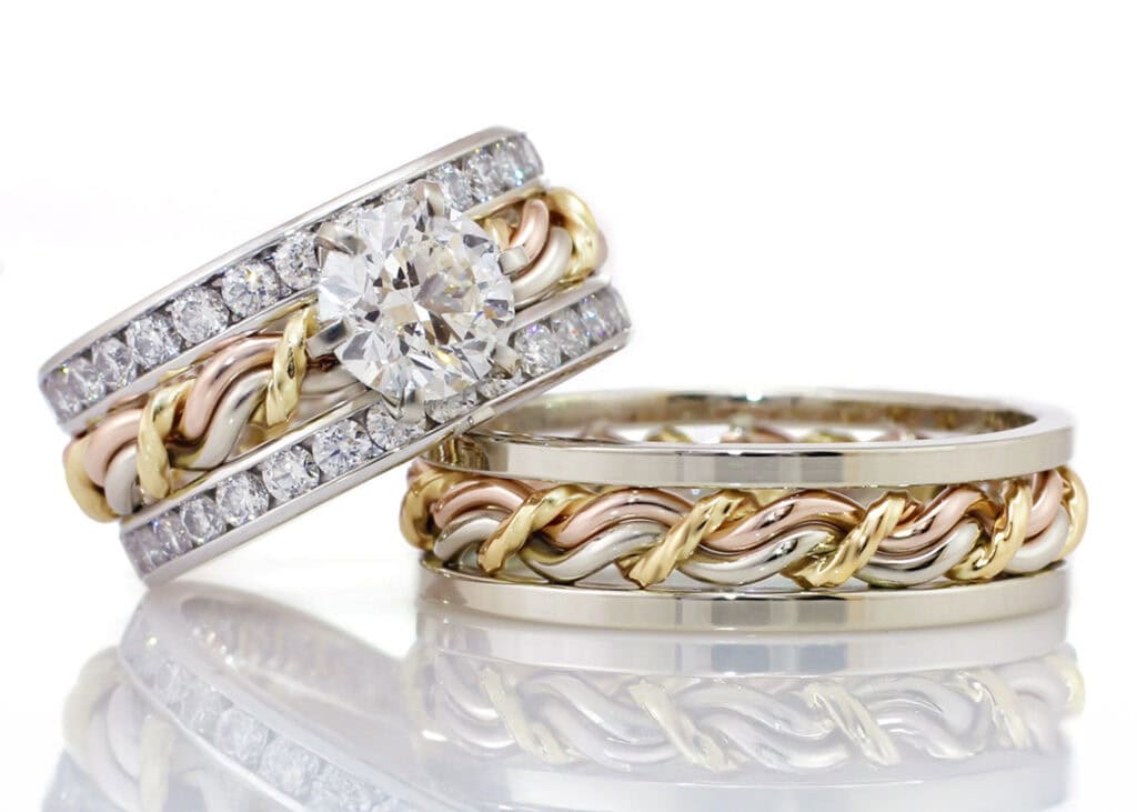 Close-up of intertwined wedding rings with diamonds and gold accents.